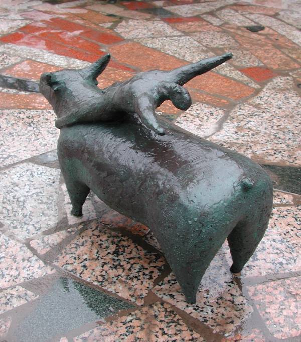 Balancing - a sculpture of a man balancing on a bull by contemporary Chinese sculptor Shen Xiaonan - other view of this bull sculpture